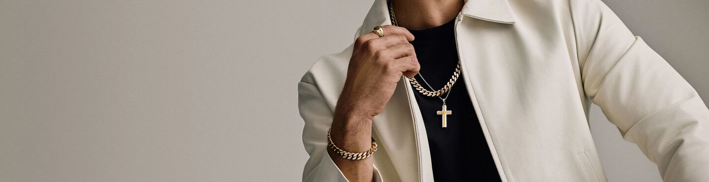 Man Wearing White Jacket with Bulova Chain Necklace Layered with Cross Pendant and Bulova Link Bracelet and Ring