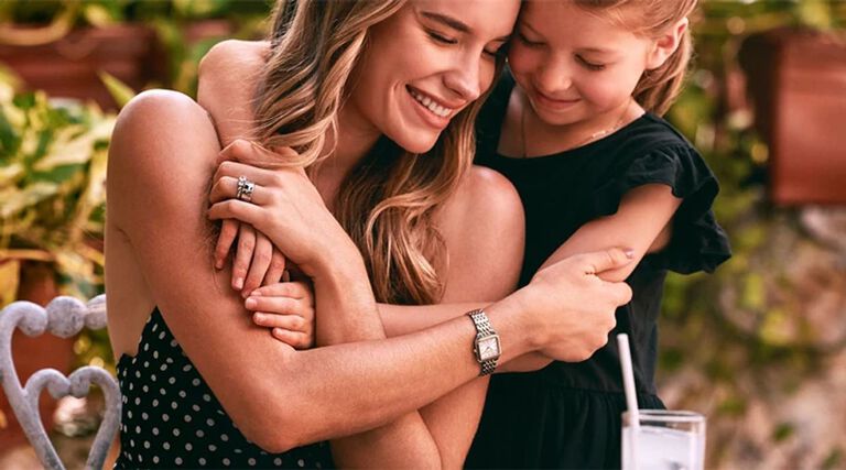 Image of a mom and daughter hugging, with the mom wearing Sutton watch model 98L330